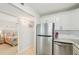 Galley kitchen leading into bedroom with stainless steel appliances and white cabinets at 117 7Th N St # 5, Bradenton Beach, FL 34217