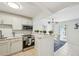 Open kitchen with stainless steel appliances and adjacent dining area at 117 7Th N St # 5, Bradenton Beach, FL 34217