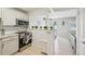 Well-lit kitchen featuring stainless steel appliances and breakfast bar at 117 7Th N St # 5, Bradenton Beach, FL 34217