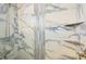 Walk-in shower with marble tiling and built-in shelving at 117 7Th N St # 5, Bradenton Beach, FL 34217