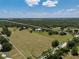 Wide aerial shot outlining the property's expansive acreage, featuring a stately home and vast greenery at 12615 River Rd, Myakka City, FL 34251
