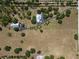 Overhead view of expansive land featuring a home with an outbuilding, with trees scattered on the property at 12615 River Rd, Myakka City, FL 34251