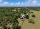 Extensive aerial view showcasing the home, surrounded by lush greenery and mature trees at 12615 River Rd, Myakka City, FL 34251