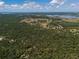 Expansive aerial view of the property featuring lush greenery and several lakes in the distance at 12615 River Rd, Myakka City, FL 34251