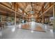 Expansive barn interior with chandeliers, and a polished dance floor at 12615 River Rd, Myakka City, FL 34251
