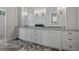 Bright bathroom featuring double sinks and vanity with stylish fixtures at 12615 River Rd, Myakka City, FL 34251