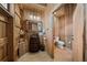 Rustic bathroom featuring a barrel sink, wooden walls, and unique fixtures for a country-style appeal at 12615 River Rd, Myakka City, FL 34251
