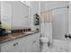 Bathroom featuring a white vanity, tile floors, and a shower tub with a decorative curtain at 12615 River Rd, Myakka City, FL 34251