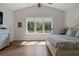 Cozy bedroom featuring a large window, bright light, and hardwood flooring at 12615 River Rd, Myakka City, FL 34251