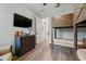 Bedroom with wood floors, modern ceiling fan, and a large built-in bunk bed at 12615 River Rd, Myakka City, FL 34251