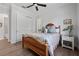 Bedroom boasts wood floors, ceiling fan, and en suite bathroom with large closet at 12615 River Rd, Myakka City, FL 34251