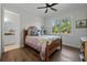 Cozy bedroom with a ceiling fan, hardwood floors, and a picturesque window view at 12615 River Rd, Myakka City, FL 34251