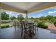 Relaxing outdoor setting with wooden furniture, a neutral ceiling, and landscape views at 12615 River Rd, Myakka City, FL 34251