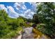 Calm creek waters reflecting the blue sky, bordered by vibrant greenery, enhancing the serene atmosphere at 12615 River Rd, Myakka City, FL 34251