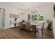 Bright dining room featuring wood floors, modern chandelier and ample natural light at 12615 River Rd, Myakka City, FL 34251