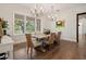 Dining room features a modern chandelier and a large window overlooking the grounds at 12615 River Rd, Myakka City, FL 34251