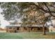 Charming two-story barn-style home with wooden shutters and a metal roof, nestled in a scenic landscape at 12615 River Rd, Myakka City, FL 34251