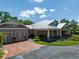 Charming single-story home featuring a brick driveway, covered porch and a sprawling landscaped yard at 12615 River Rd, Myakka City, FL 34251