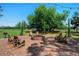 Inviting brick fire pit area with Adirondack chairs, perfect for outdoor relaxation and socializing at 12615 River Rd, Myakka City, FL 34251