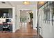 Open foyer featuring hardwood floors, a view to the living room, and a separate office space at 12615 River Rd, Myakka City, FL 34251