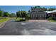 Attached two-car garage with matching doors, brick accents and a paved driveway at 12615 River Rd, Myakka City, FL 34251