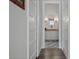 Hallway leading to a well-lit bathroom with beautiful tile flooring at 12615 River Rd, Myakka City, FL 34251