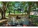 Rustic horse stall with saddle rack nestled among mature trees, offering a charming equestrian feature at 12615 River Rd, Myakka City, FL 34251