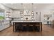 Stunning kitchen featuring an island with seating, modern appliances, and open shelving at 12615 River Rd, Myakka City, FL 34251