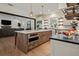 Spacious kitchen featuring an island with seating, stainless steel appliances, and modern fixtures at 12615 River Rd, Myakka City, FL 34251