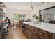 Kitchen island with seating and appliances overlooking a dining area at 12615 River Rd, Myakka City, FL 34251