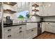 Kitchen featuring a farmhouse sink, stainless steel appliances, and open shelving at 12615 River Rd, Myakka City, FL 34251