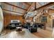 Inviting living room with leather furniture, wooden floors, and rustic decor accents under a vaulted ceiling at 12615 River Rd, Myakka City, FL 34251