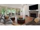 Cozy living room with a comfortable sofa, fireplace, and large sliding doors that open to the outside at 12615 River Rd, Myakka City, FL 34251