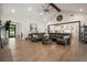 Spacious living room featuring hardwood floors, a fireplace, and an open layout to the kitchen at 12615 River Rd, Myakka City, FL 34251