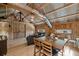 Spacious open-concept room with rustic wood finishes, comfortable seating, and dining area at 12615 River Rd, Myakka City, FL 34251