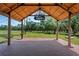 Open-air pavilion with a brick base and a wooden roof structure, providing a perfect spot for outdoor events at 12615 River Rd, Myakka City, FL 34251