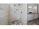 Modern walk-in shower featuring unique tile design and dual shower heads at 12615 River Rd, Myakka City, FL 34251