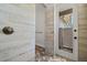 Contemporary shower area featuring brick tile floor, walk out access and open design at 12615 River Rd, Myakka City, FL 34251