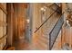 Wood staircase with black railing and wooden walls, adding rustic charm to the property at 12615 River Rd, Myakka City, FL 34251