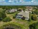 Aerial view showcasing the home's screened-in pool, mature landscaping, and serene backyard setting at 12810 Magpie Pl, Bradenton, FL 34212