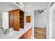 Bathroom featuring double sinks, wood cabinets, and a view into the bedroom at 12810 Magpie Pl, Bradenton, FL 34212