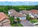 A high-angle view showcasing the home's layout, including the tile roof and brick driveway at 13902 Messina Loop, Bradenton, FL 34211