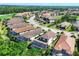 Aerial view of a beautiful community with tile roofs, pools, and tropical landscaping at 13902 Messina Loop, Bradenton, FL 34211