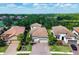 Aerial view of homes with tile roofs, lush landscaping, and well-manicured lawns at 13902 Messina Loop, Bradenton, FL 34211