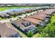 Community aerial view showcasing tile roofs, mature landscaping, and a tranquil lake at 13902 Messina Loop, Bradenton, FL 34211