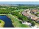 Breathtaking aerial view showcasing a golf course next to a lake and the community at 13902 Messina Loop, Bradenton, FL 34211
