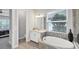 Bright bathroom featuring a soaking tub, vanity with marble countertop, and natural light at 13902 Messina Loop, Bradenton, FL 34211