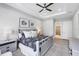 A bright main bedroom with neutral decor, a ceiling fan, and ensuite bathroom access at 13902 Messina Loop, Bradenton, FL 34211