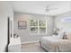 Cozy bedroom featuring a large window, ceiling fan, and neutral decor at 13902 Messina Loop, Bradenton, FL 34211