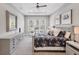 A bright main bedroom with neutral decor, tray ceiling, ceiling fan, and serene window view at 13902 Messina Loop, Bradenton, FL 34211